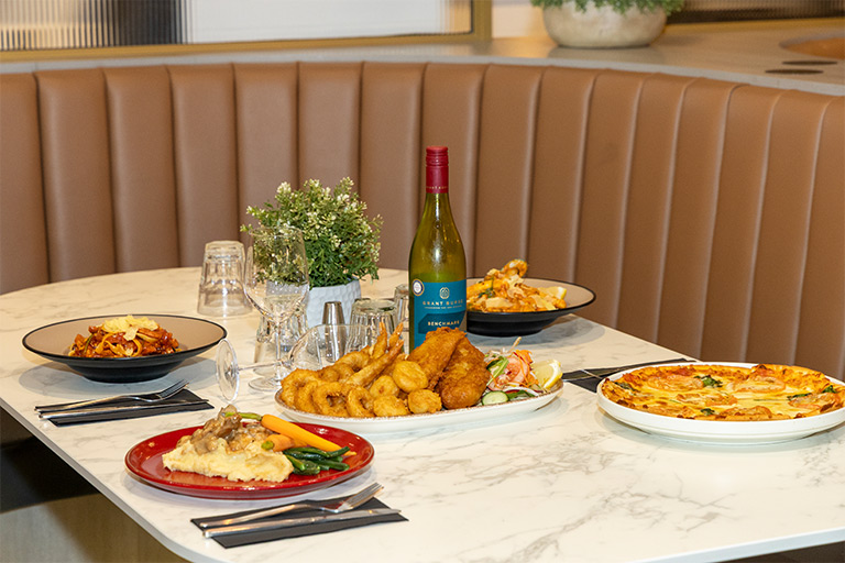 Multiple Food dishes in our booth seating at Essence Restaurant